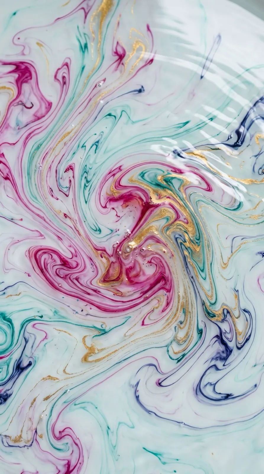 Marbled swirls of pink, teal and gold ink
